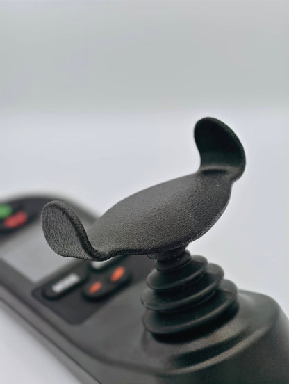 A black joystick topper connected to a power wheelchair joystick