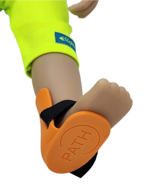 Orange toy brace on doll's foot