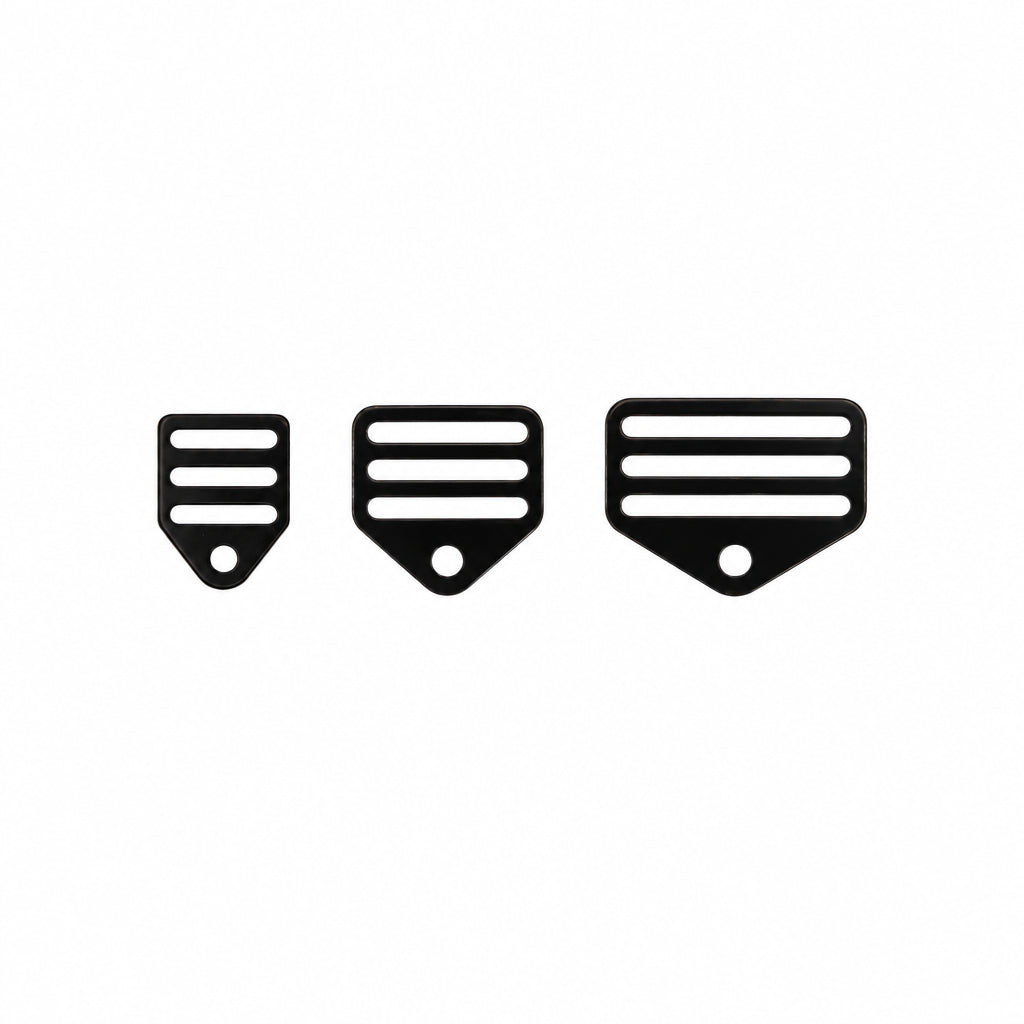 Three black webbing harness mounts on a white background